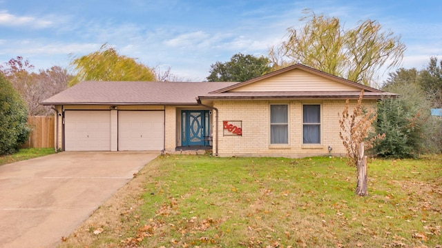 single story home with a garage and a front lawn