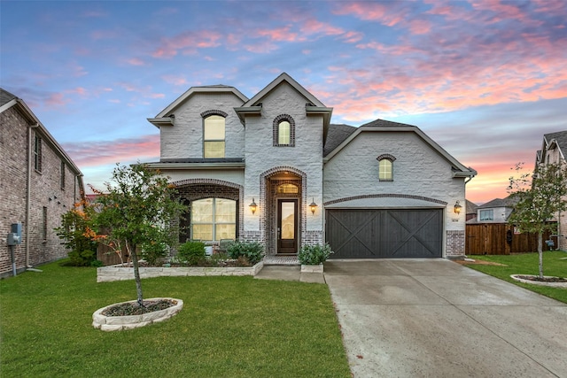 french provincial home featuring a yard and a garage