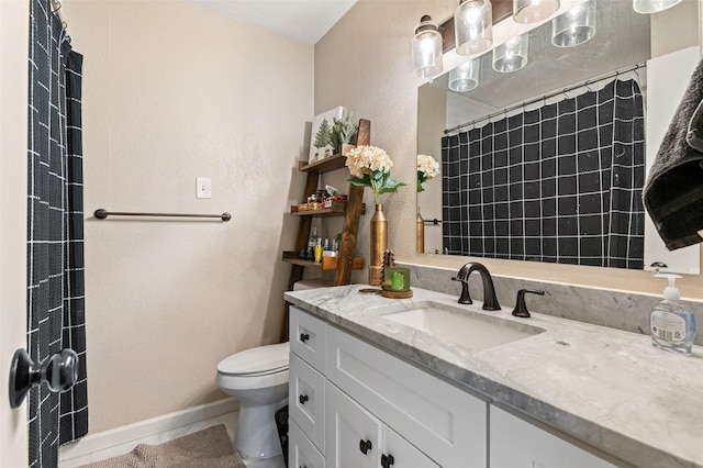 bathroom featuring tile patterned floors, vanity, toilet, and curtained shower