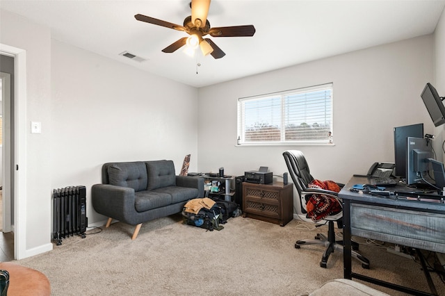 office area featuring radiator, light carpet, and ceiling fan