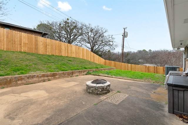 view of patio / terrace with central AC and a fire pit