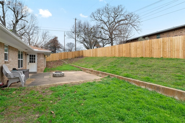 view of yard featuring a fire pit and a patio area