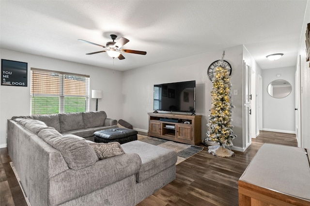 living room with ceiling fan and dark wood-type flooring