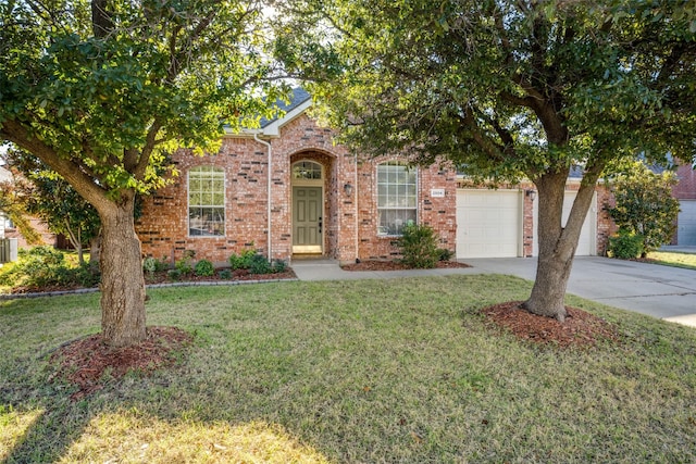 view of front of property with a garage and a front yard