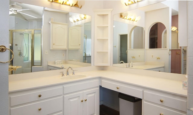 bathroom featuring ceiling fan, a shower with door, and vanity