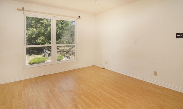 empty room with light hardwood / wood-style flooring