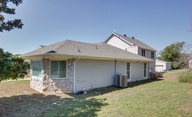 back of house featuring a lawn and central AC