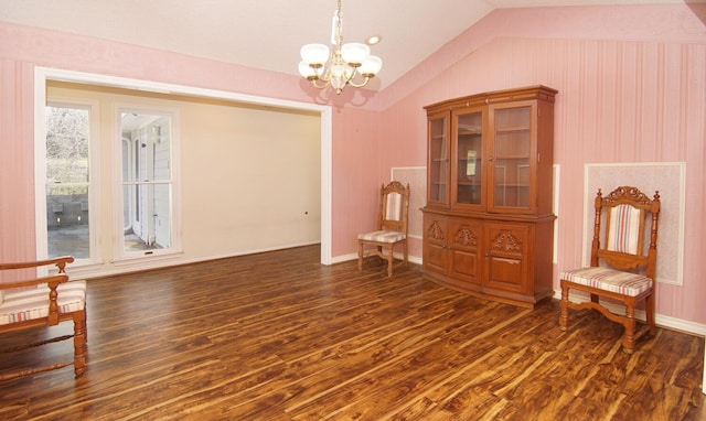 interior space with a notable chandelier, dark wood-type flooring, and vaulted ceiling