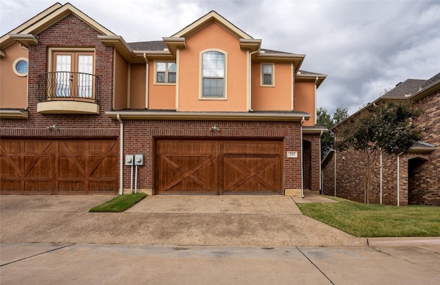 view of front of house with a garage and a balcony