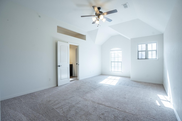 carpeted empty room featuring vaulted ceiling and ceiling fan