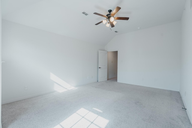 unfurnished room with light carpet, vaulted ceiling, and ceiling fan