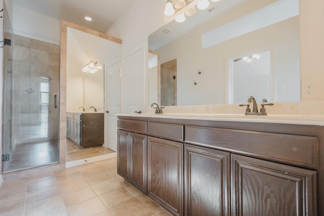 bathroom with tile patterned flooring, vanity, ceiling fan, and a shower with shower door