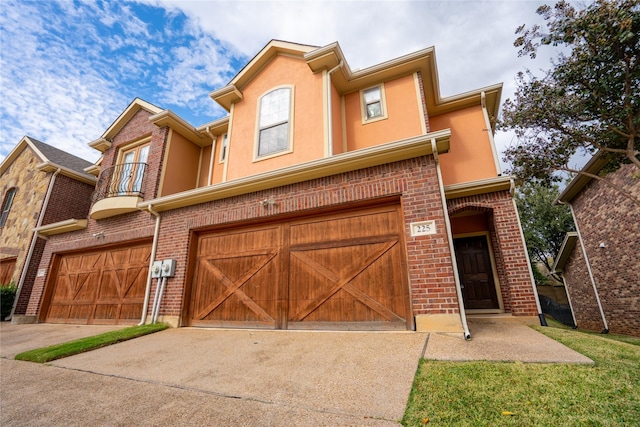 multi unit property featuring a balcony and a garage