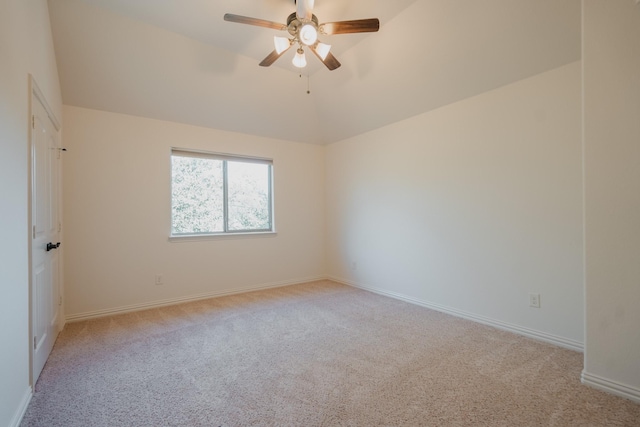 carpeted empty room featuring ceiling fan and lofted ceiling