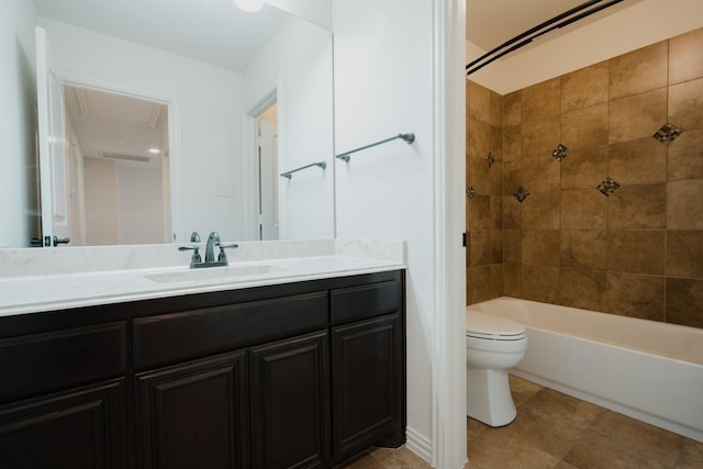 full bathroom featuring vanity, tiled shower / bath combo, and toilet