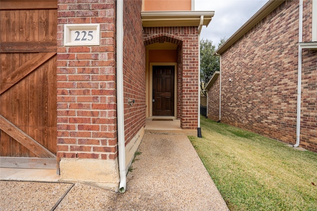 doorway to property with a lawn