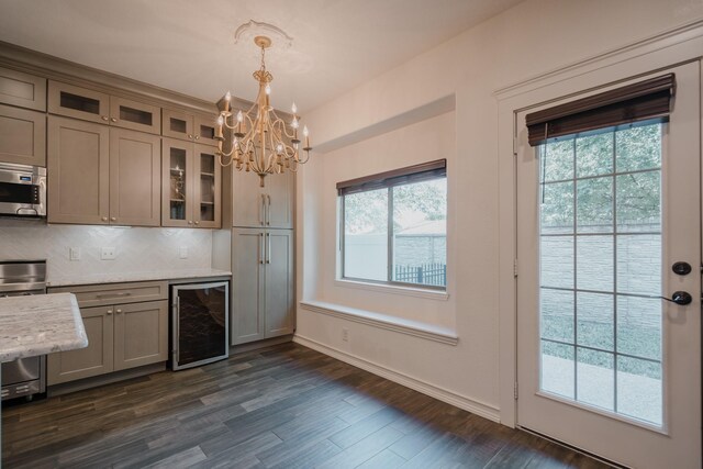 kitchen featuring pendant lighting, wine cooler, dark hardwood / wood-style floors, stainless steel appliances, and a chandelier