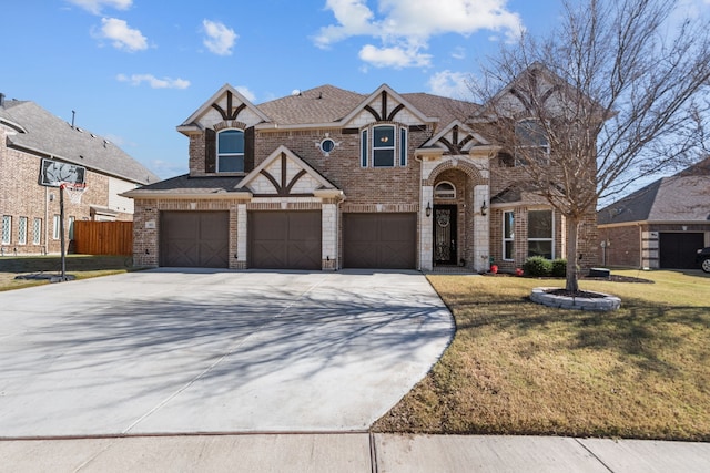 view of front of house featuring a garage and a front lawn