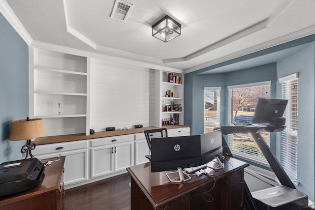 office with dark hardwood / wood-style flooring, a tray ceiling, a textured ceiling, and built in shelves