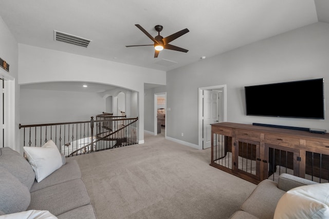 living room featuring lofted ceiling, light carpet, and ceiling fan