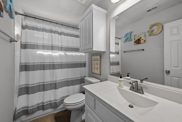 bathroom with vanity, a shower with shower curtain, and toilet