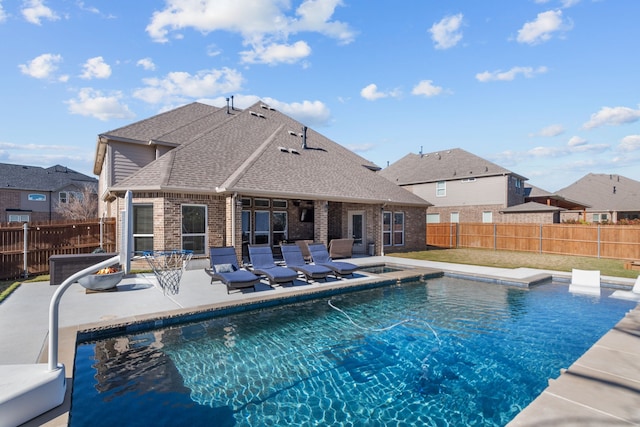 view of pool featuring a jacuzzi and a patio