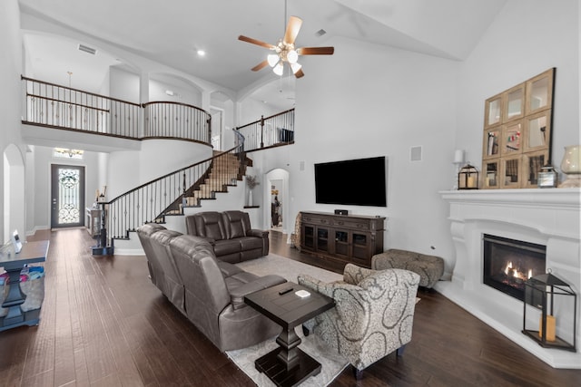 living room featuring ceiling fan, dark hardwood / wood-style flooring, and high vaulted ceiling