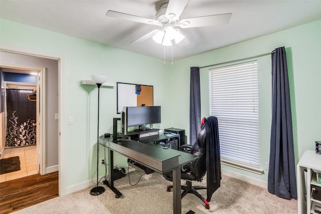 home office featuring ceiling fan and carpet