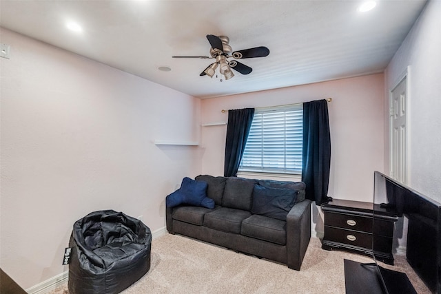 living room with ceiling fan and light colored carpet