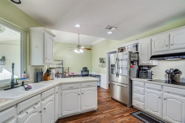 kitchen with kitchen peninsula, stainless steel fridge with ice dispenser, sink, and white cabinets