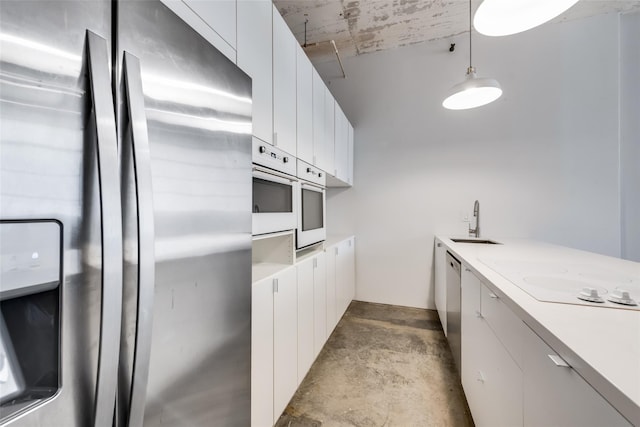 kitchen featuring white cabinets, pendant lighting, white appliances, and sink