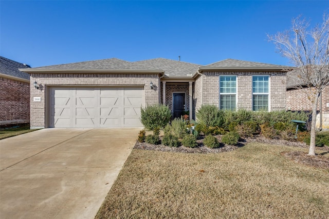 single story home featuring a garage and a front lawn