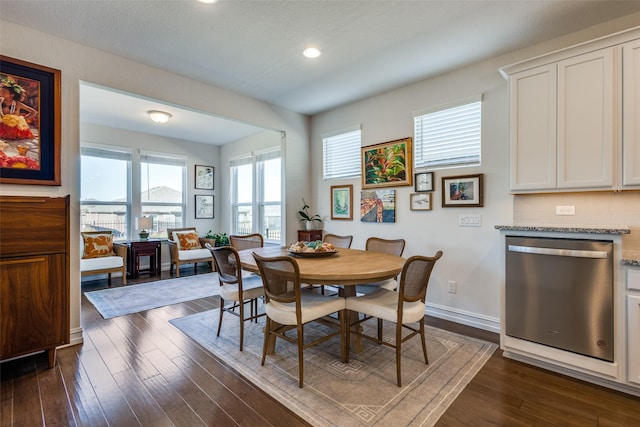 dining space with dark hardwood / wood-style flooring