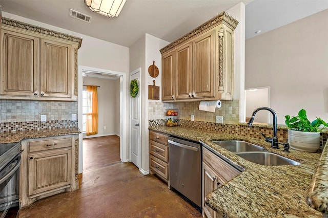 kitchen with stainless steel appliances, dark stone counters, visible vents, and a sink