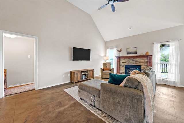 living room featuring baseboards, high vaulted ceiling, a stone fireplace, and a ceiling fan