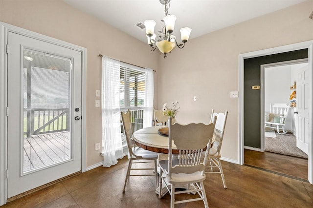 dining space featuring a notable chandelier, baseboards, concrete flooring, and visible vents