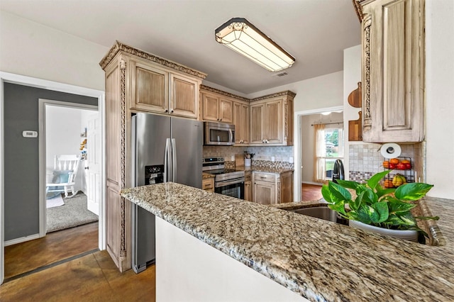 kitchen with light stone counters, visible vents, a sink, stainless steel appliances, and tasteful backsplash