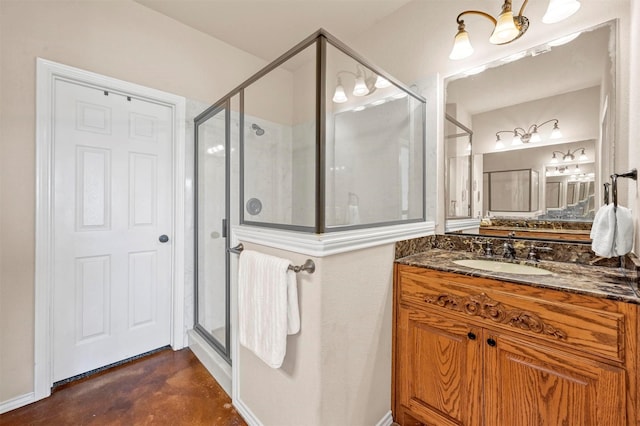 bathroom with baseboards, vanity, concrete flooring, and a shower stall