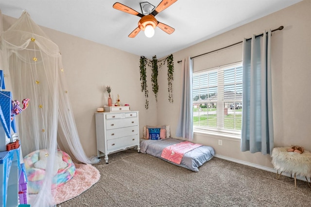 carpeted bedroom featuring a ceiling fan and baseboards