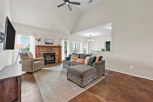 living room featuring baseboards, concrete flooring, ceiling fan with notable chandelier, a fireplace, and high vaulted ceiling