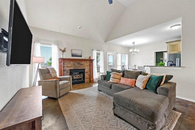 living area featuring a stone fireplace, an inviting chandelier, baseboards, and high vaulted ceiling