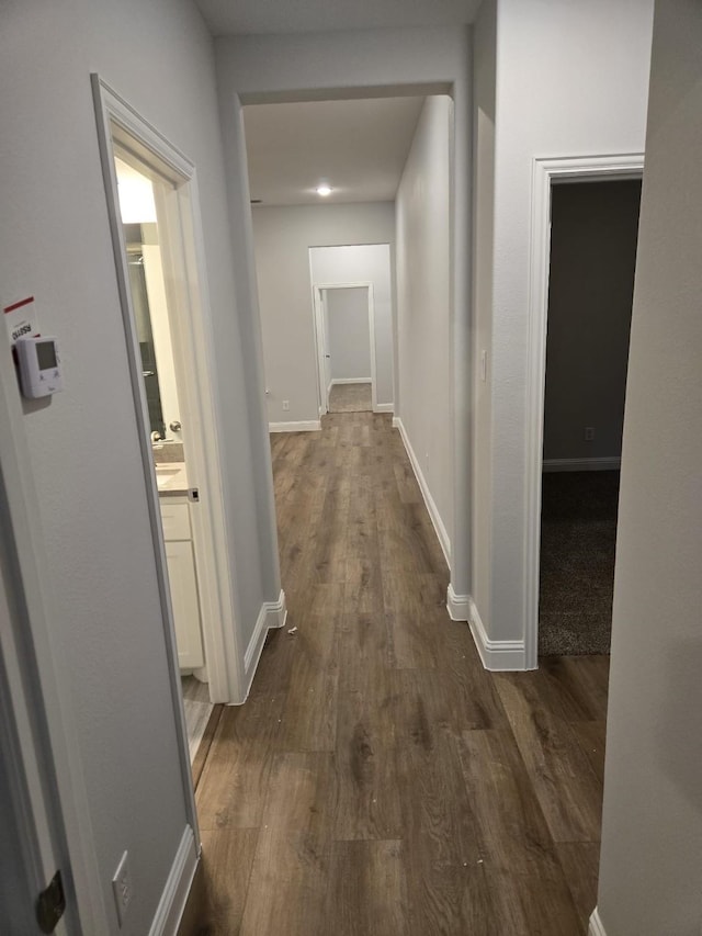 hallway with dark wood-type flooring