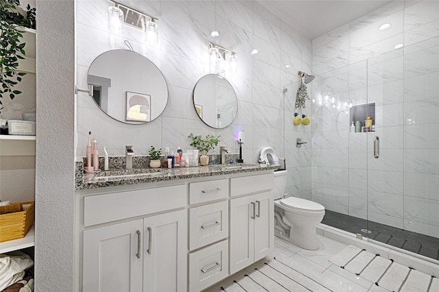 bathroom featuring vanity, toilet, and a shower with door