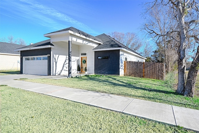 view of front facade featuring a garage and a front lawn