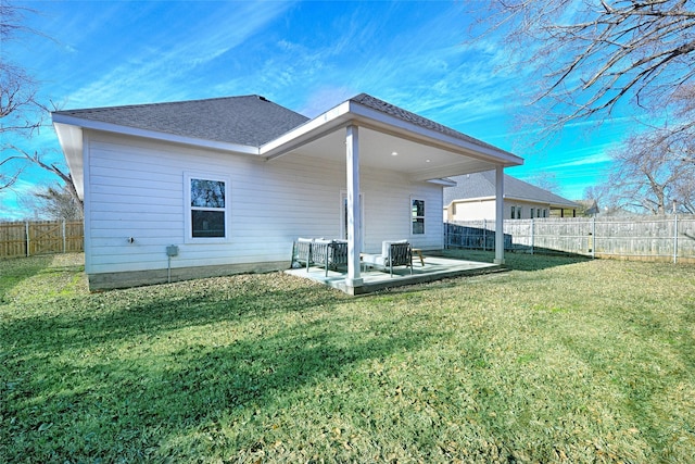 back of house with a lawn and a patio area