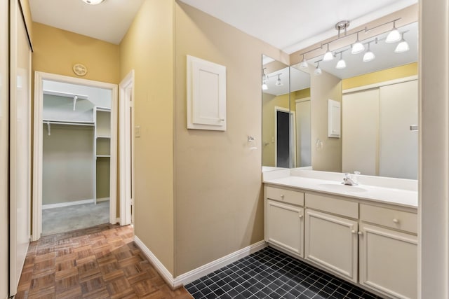 bathroom featuring vanity and parquet flooring