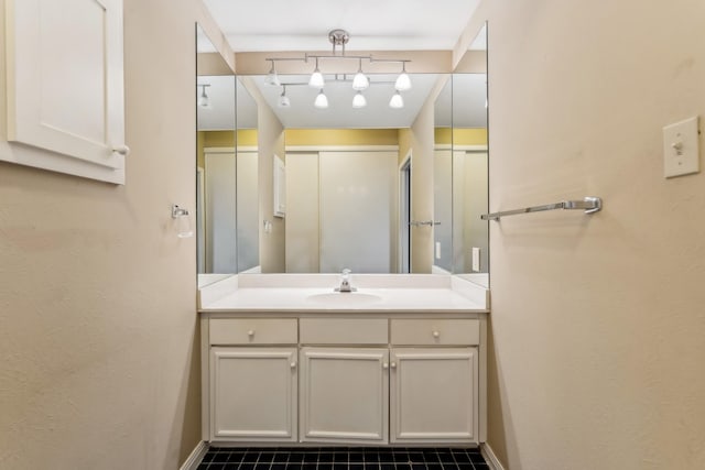 bathroom with tile patterned flooring and vanity