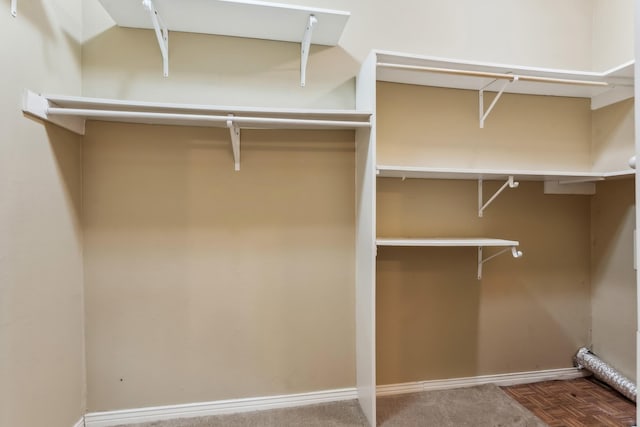 spacious closet featuring parquet flooring