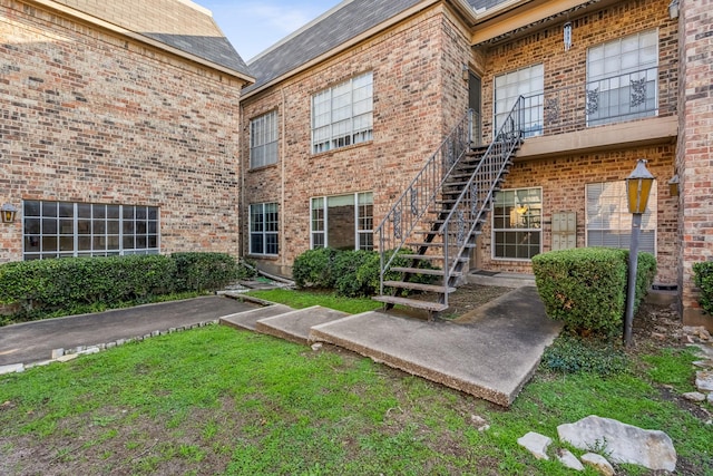 doorway to property with a yard