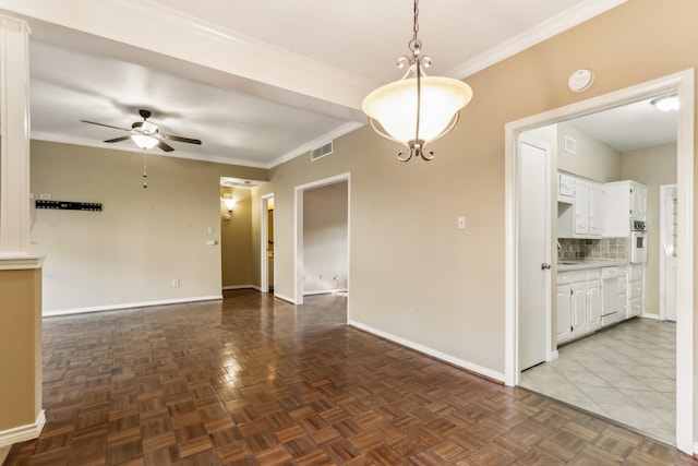 unfurnished room featuring dark parquet flooring, ceiling fan, and crown molding